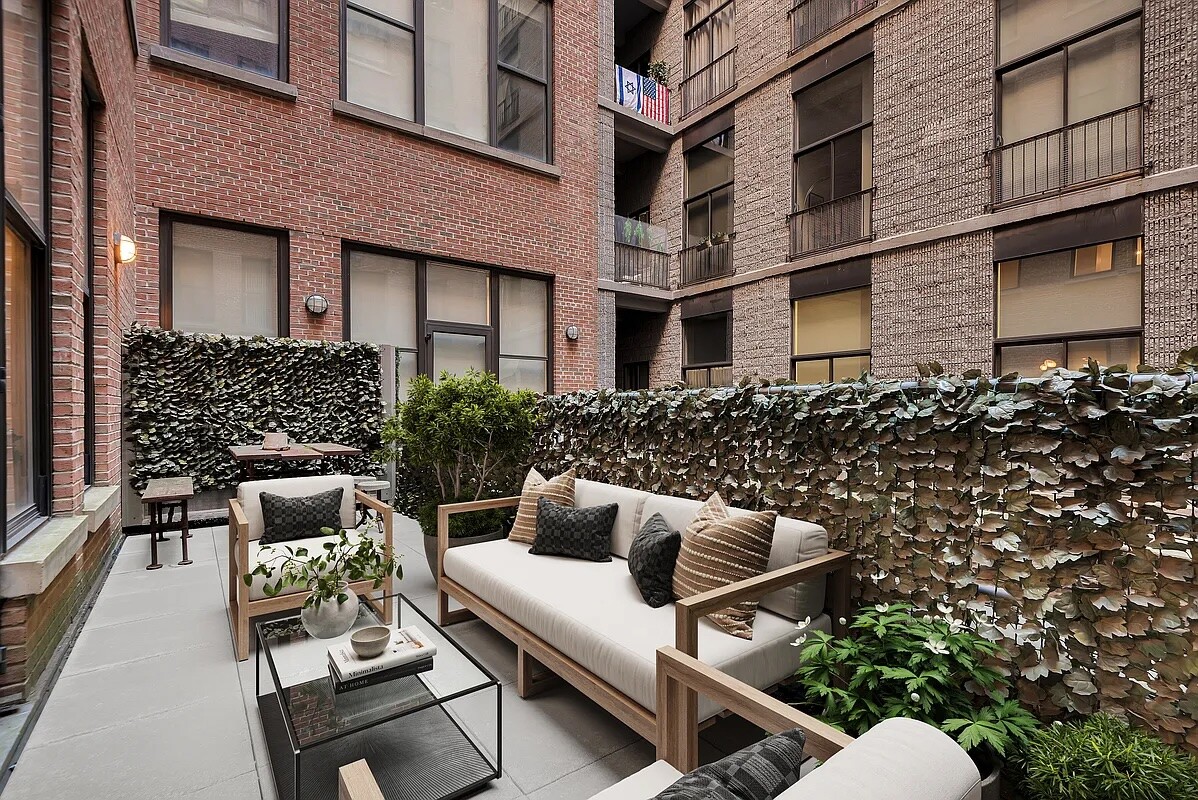 260 Park Avenue South, Unit 2E Manhattan, NY 10010 - Photo 3 of 20 a backyard of a house with chairs table and sofas