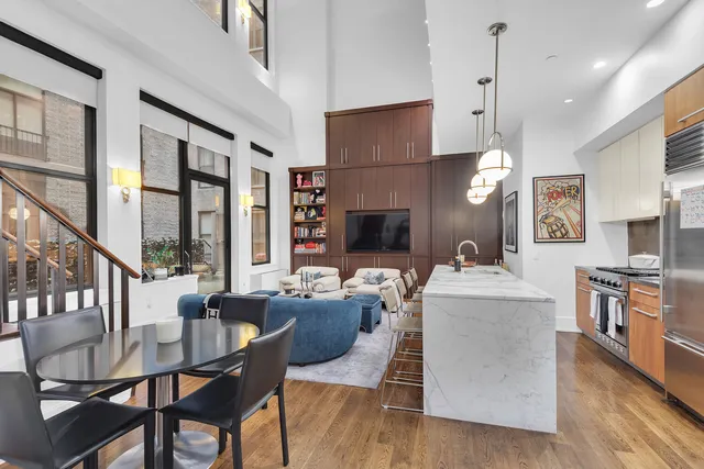 a kitchen with a refrigerator a sink and chandelier