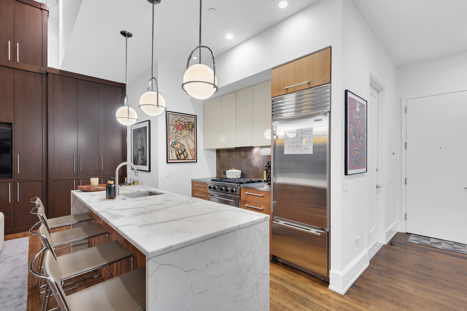 260 Park Avenue South, Unit 2E Manhattan, NY 10010 - Photo 7 of 20 a kitchen with a refrigerator a sink and cabinets