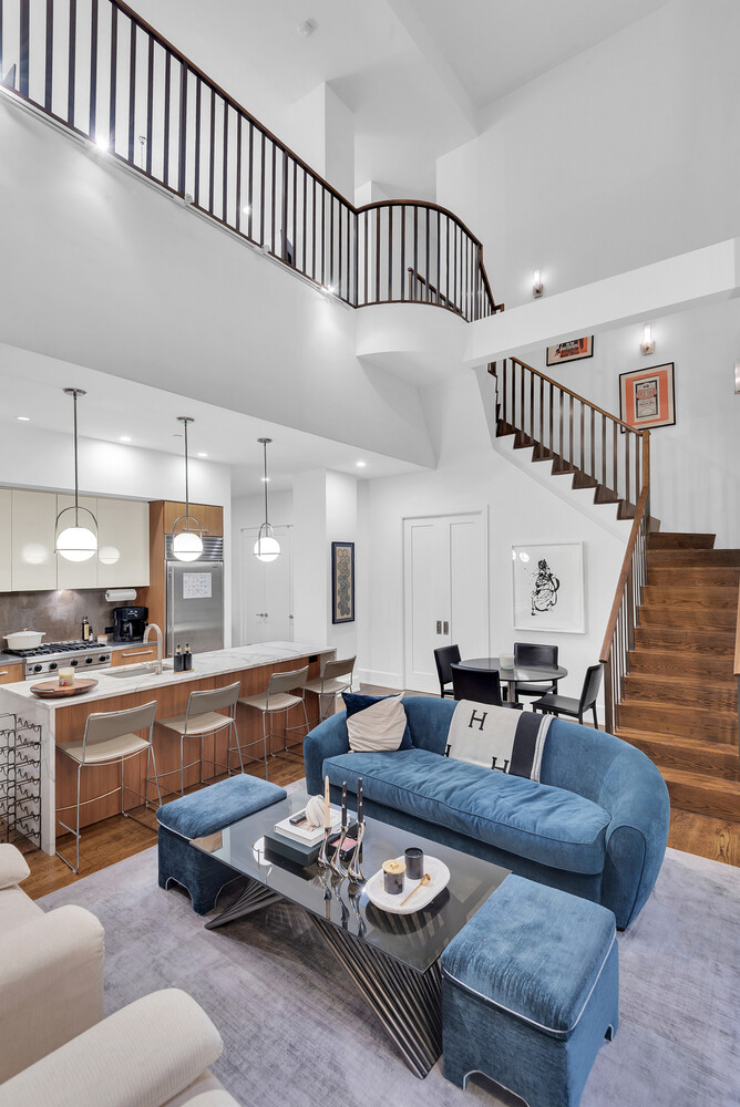260 Park Avenue South, Unit 2E Manhattan, NY 10010 - Photo 9 of 20 a living room with furniture kitchen view and a wooden floor