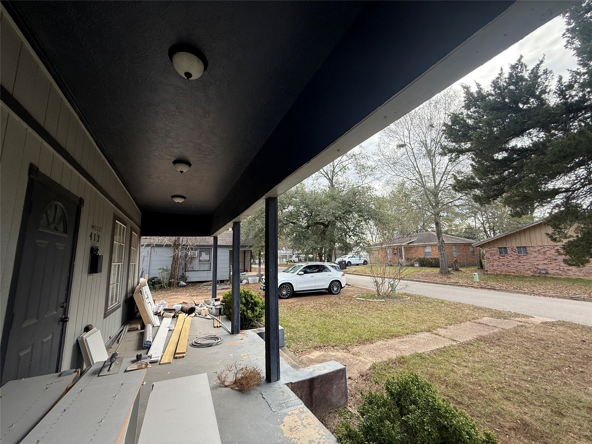 412 Waco Street Conroe, TX 77301 - Photo 27 of 50 a view of a porch with furniture and a tree