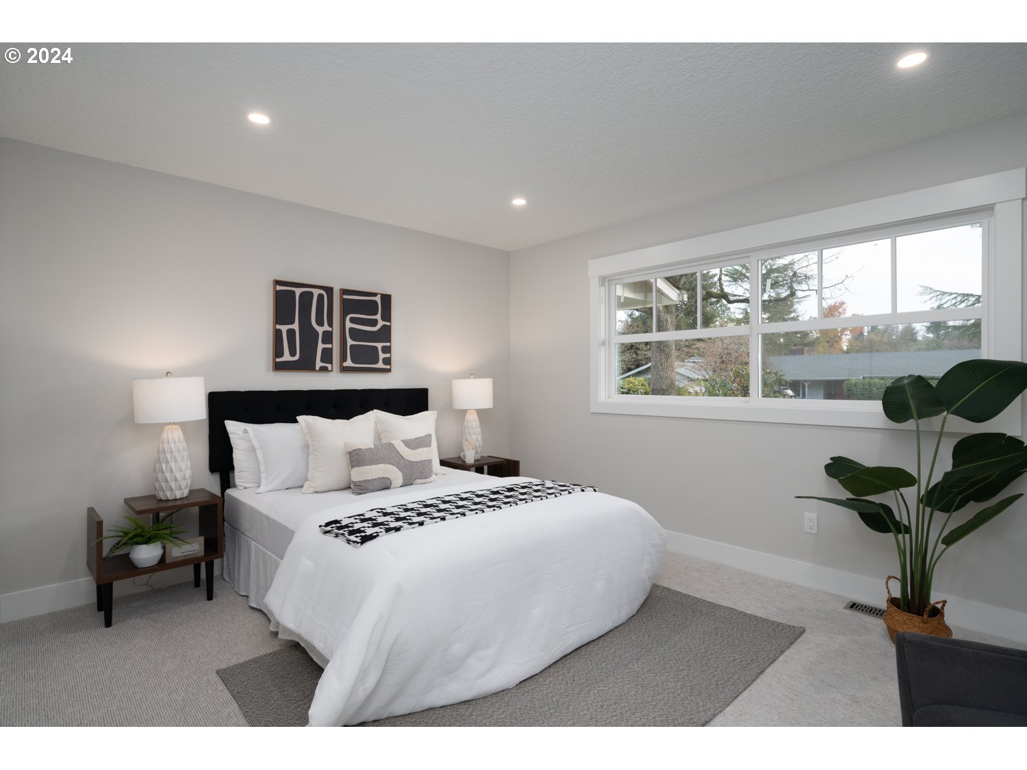 8889 Southwest Becker Drive Portland, OR 97223 - Photo 17 of 32 a bedroom with a bed and a large window