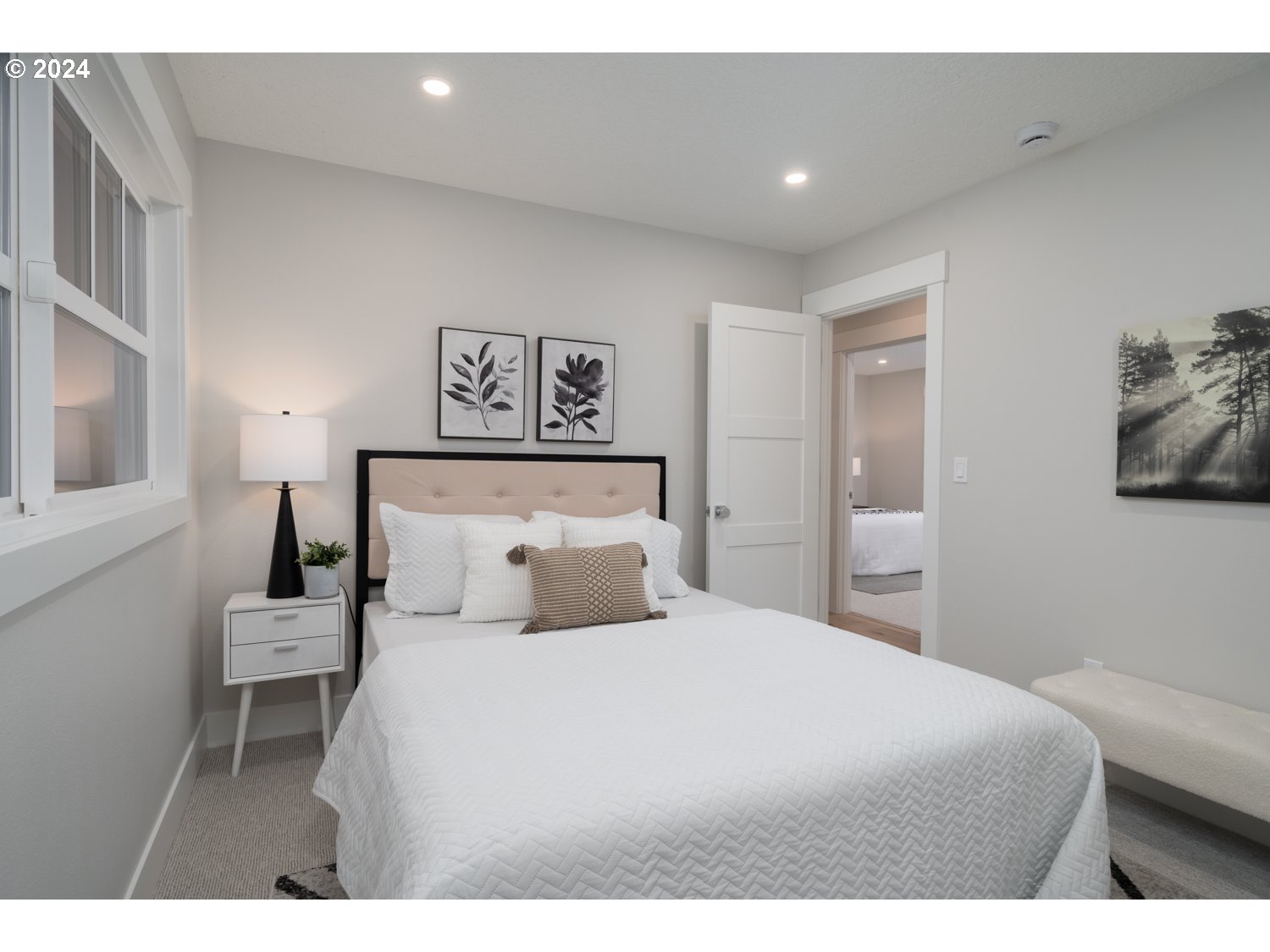 8889 Southwest Becker Drive Portland, OR 97223 - Photo 23 of 32 a bedroom with a large bed and a night stand