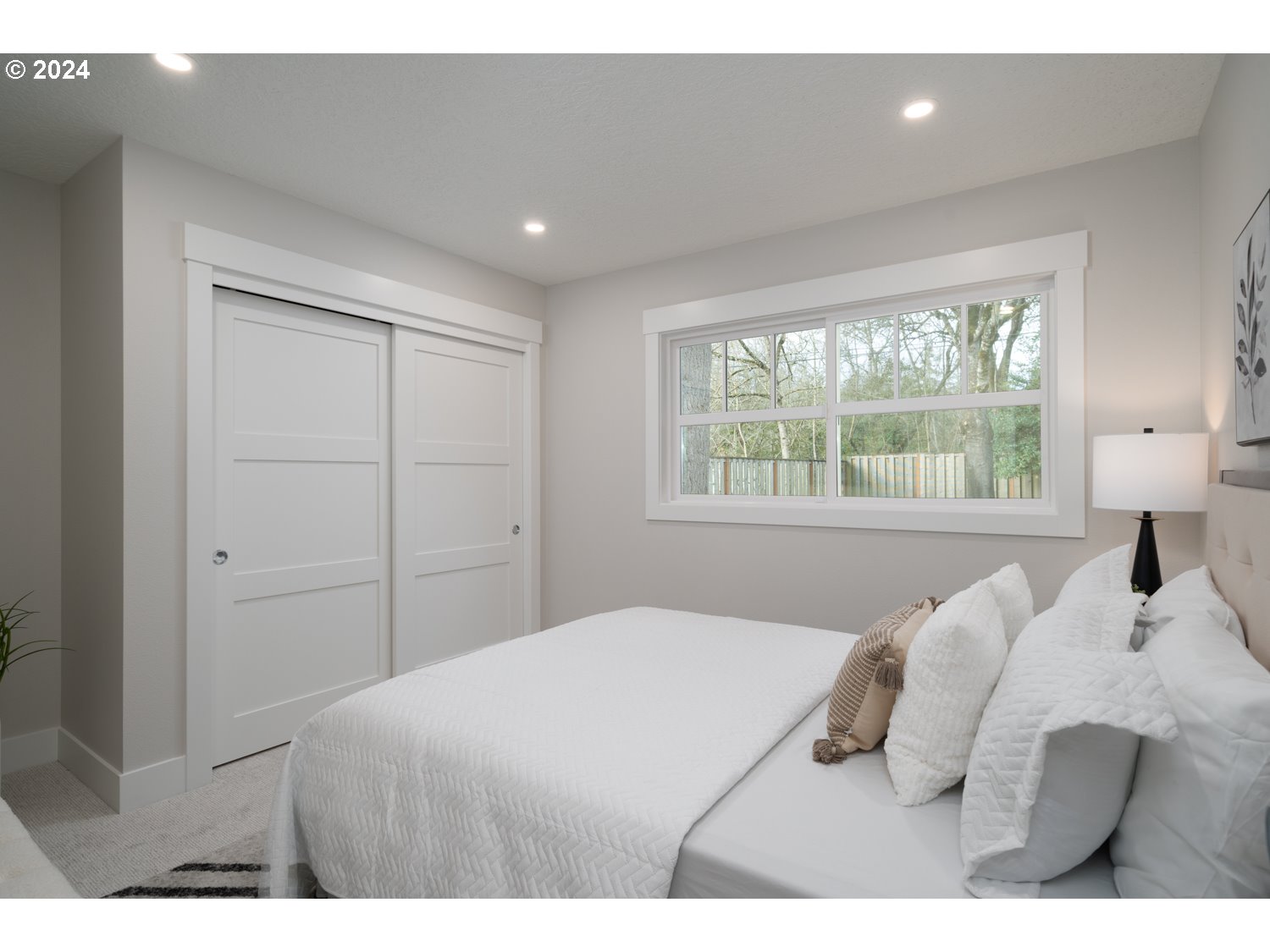 8889 Southwest Becker Drive Portland, OR 97223 - Photo 24 of 32 a bedroom with a bed and a large window