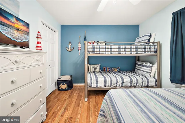 a bedroom with two beds and painting on the wall