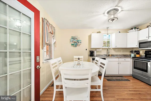 a view of a dining room with furniture and wooden floor