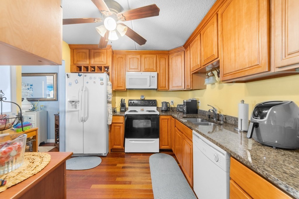 100 Cove Way, Unit 608 Quincy, MA 02169 - Photo 11 of 26 a kitchen with stainless steel appliances granite countertop a refrigerator a stove and a sink with cabinets