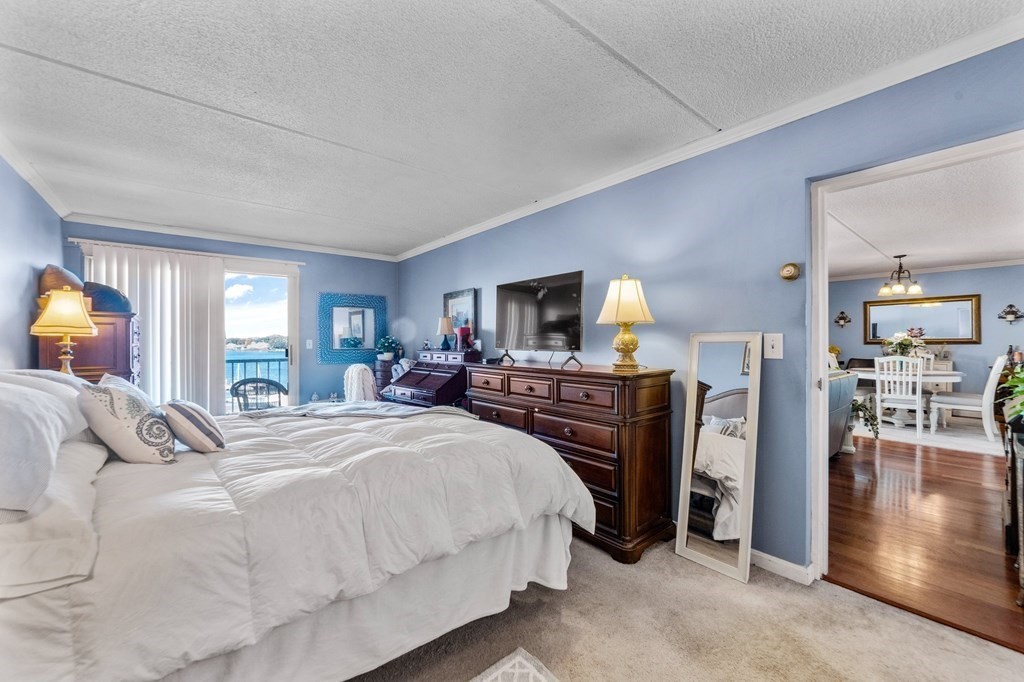 100 Cove Way, Unit 608 Quincy, MA 02169 - Photo 16 of 26 a bed room with a bed and a tv