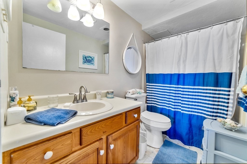 100 Cove Way, Unit 608 Quincy, MA 02169 - Photo 18 of 26 a bathroom with a sink a toilet and a mirror