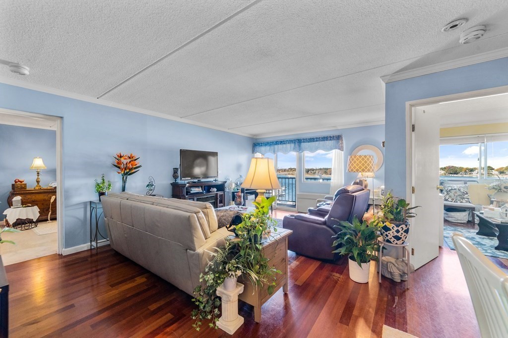 100 Cove Way, Unit 608 Quincy, MA 02169 - Photo 7 of 26 a living room with furniture fireplace and wooden floor