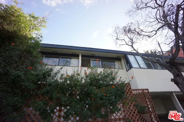 a front view of house with a garden