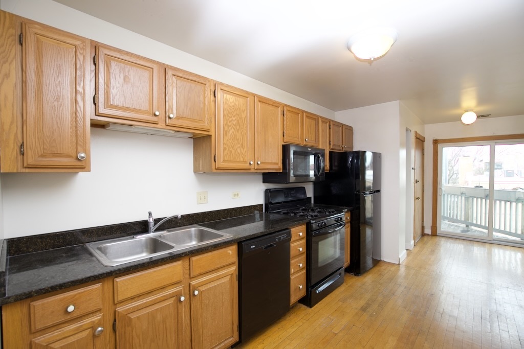 6717 North Sheridan Road, Unit 3S Chicago, IL 60626 - Photo 2 of 20 a kitchen with stainless steel appliances granite countertop a refrigerator and a stove top oven