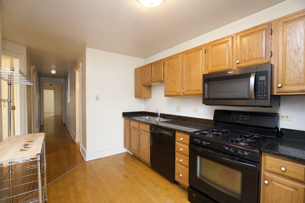6717 North Sheridan Road, Unit 3S Chicago, IL 60626 - Photo 4 of 20 a kitchen with stainless steel appliances a stove a microwave a sink and cabinets