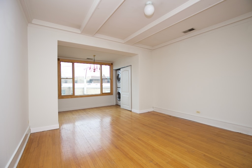 6717 North Sheridan Road, Unit 3S Chicago, IL 60626 - Photo 7 of 20 wooden floor in an empty room with a window
