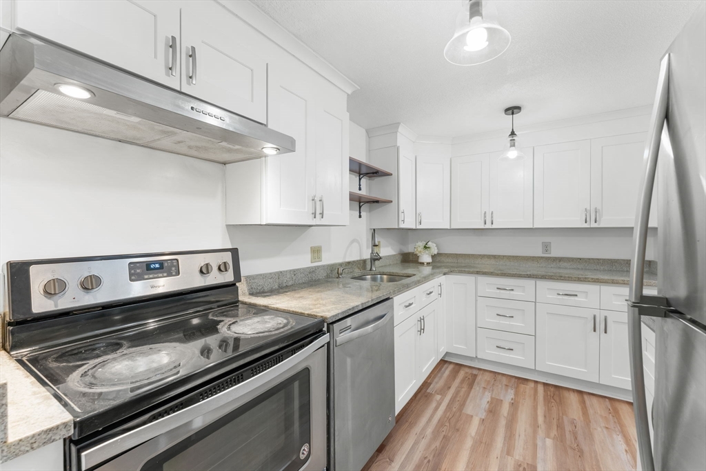 a kitchen with a stove oven and white cabinets