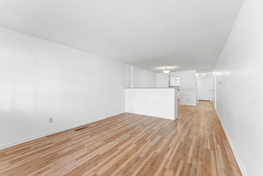 5 Elm Street, Unit 1 Acton, MA 01720 - Photo 22 of 30 a view of a room with wooden floor and white walls