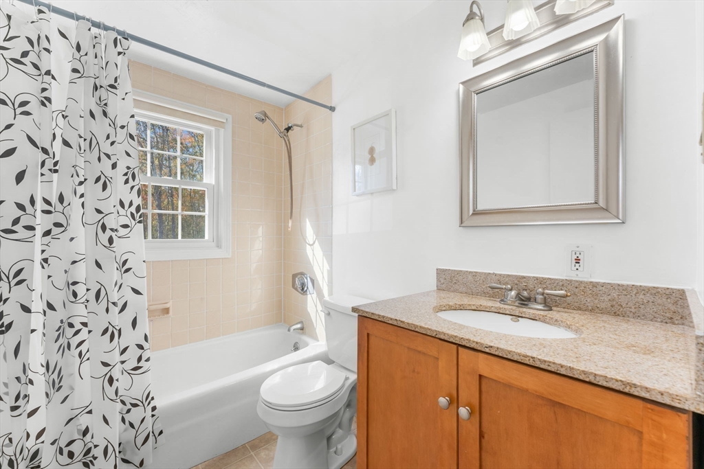 5 Elm Street, Unit 1 Acton, MA 01720 - Photo 4 of 30 a bathroom with a granite countertop sink toilet and shower