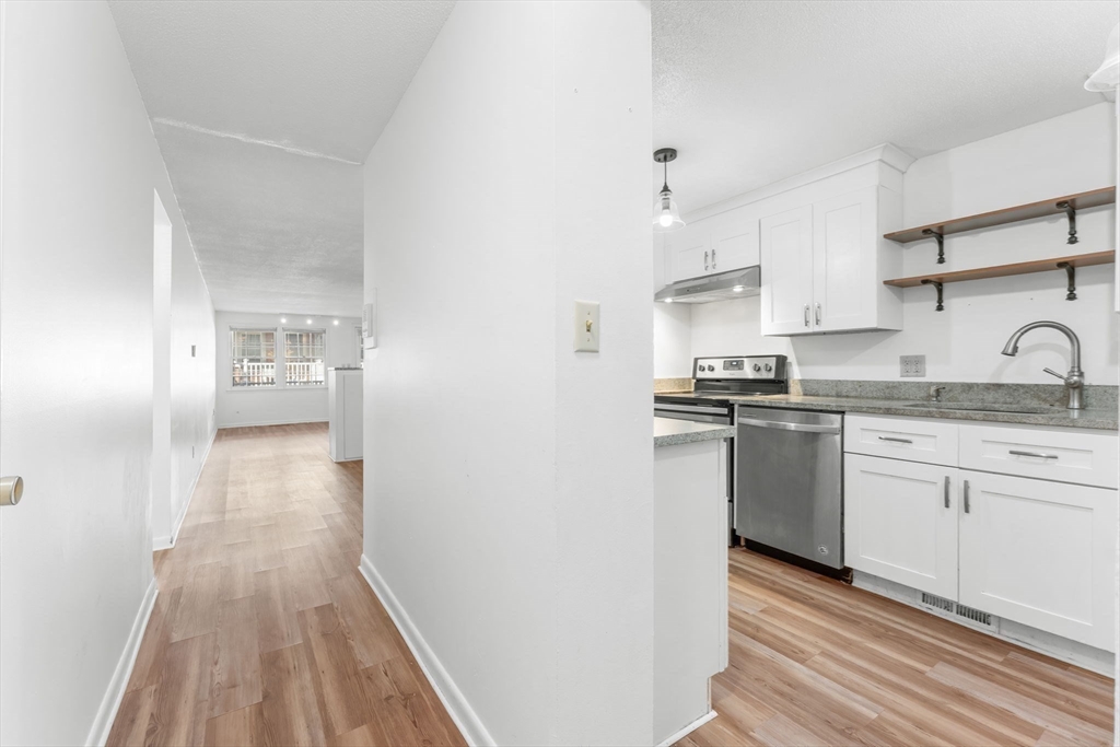 5 Elm Street, Unit 1 Acton, MA 01720 - Photo 9 of 30 a kitchen with granite countertop a refrigerator and a sink