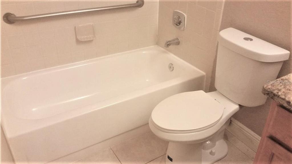 1049 South Hiawassee Road, Unit 3416 Orlando, FL 32835 - Photo 13 of 22 a white toilet sitting next to a bath tub