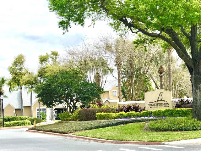 a view of a white house with a yard and plants
