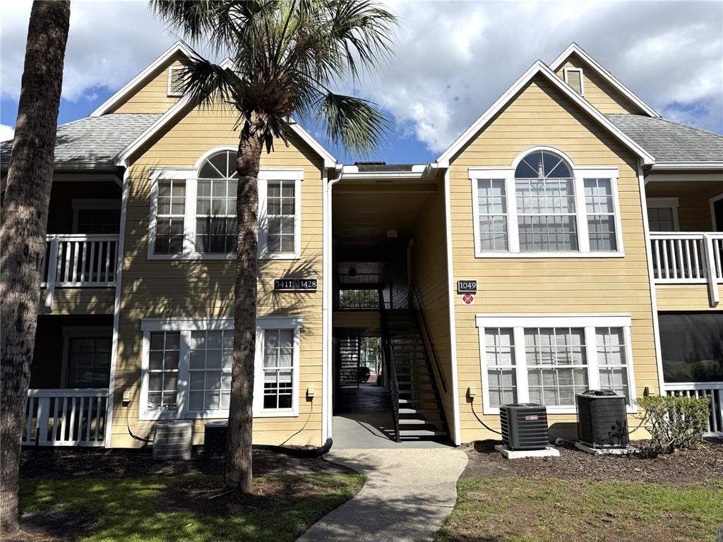 1049 South Hiawassee Road, Unit 3416 Orlando, FL 32835 - Photo 16 of 22 a view of a brick house with many windows next to a yard