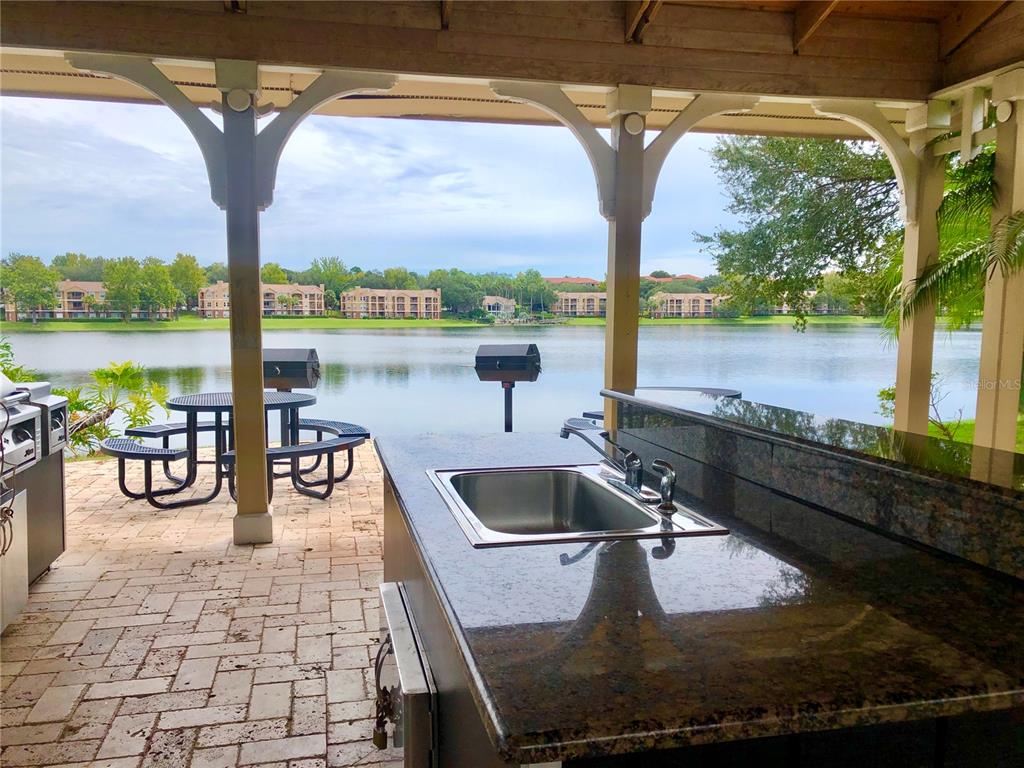 1049 South Hiawassee Road, Unit 3416 Orlando, FL 32835 - Photo 17 of 22 a view of swimming pool with a table and chairs under an umbrella