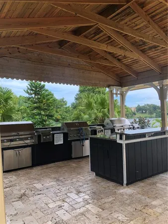 a view of a backyard with couches chairs and wooden floor