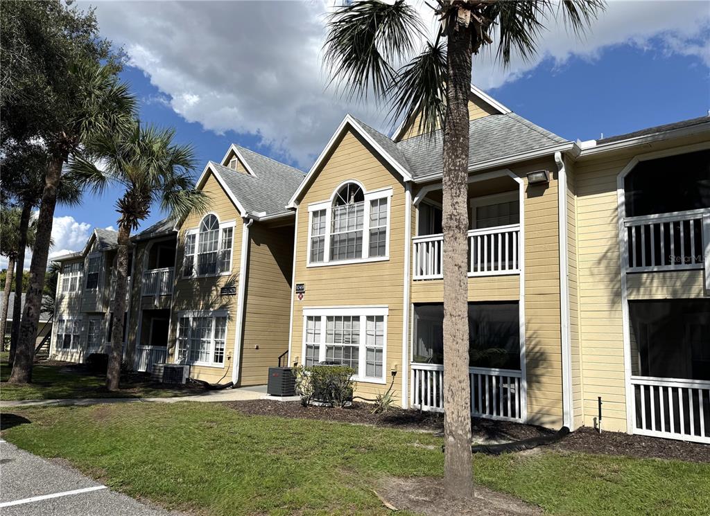 1049 South Hiawassee Road, Unit 3416 Orlando, FL 32835 - Photo 2 of 22 a front view of a house with a yard