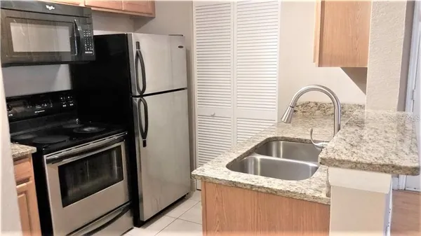 a kitchen with a sink stove and refrigerator