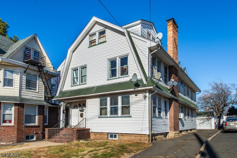 a view of a house with a yard and balcony