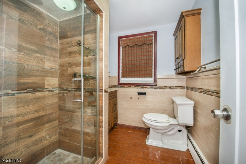 86 Watsessing Avenue, Unit 1 Bloomfield, NJ 07003 - Photo 11 of 21 a bathroom with a toilet and a shower