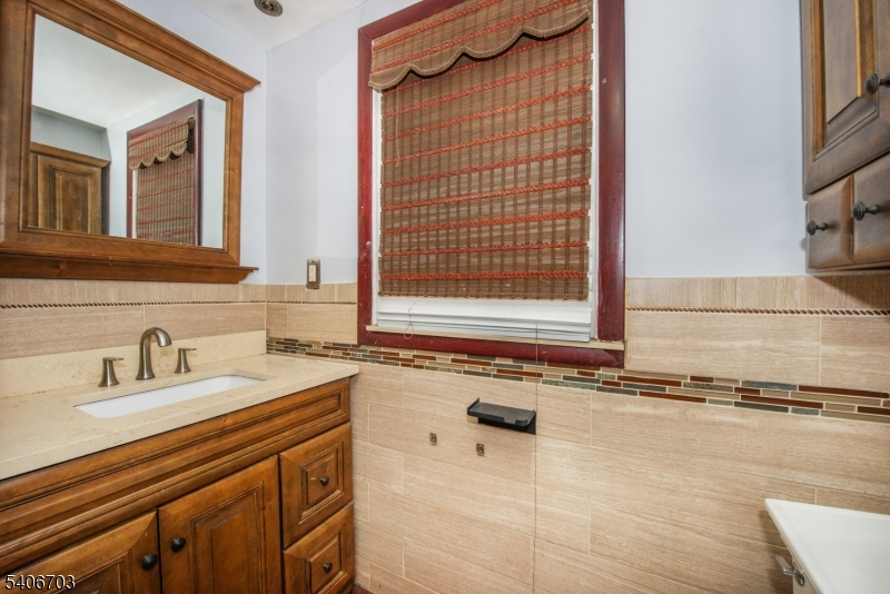 86 Watsessing Avenue, Unit 1 Bloomfield, NJ 07003 - Photo 12 of 21 a bathroom with a sink and a mirror