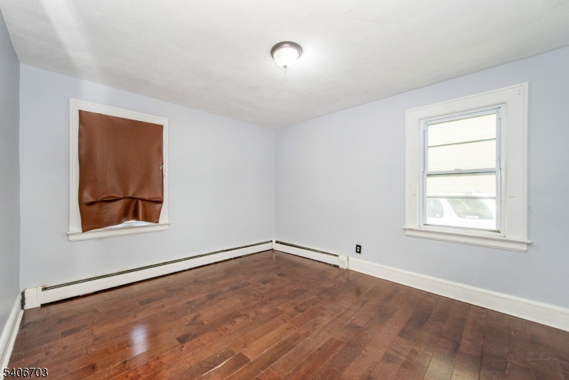 86 Watsessing Avenue, Unit 1 Bloomfield, NJ 07003 - Photo 13 of 21 an empty room with windows