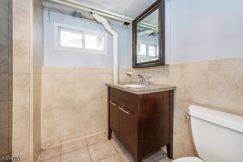 86 Watsessing Avenue, Unit 1 Bloomfield, NJ 07003 - Photo 19 of 21 a bathroom with a sink a toilet and vanity
