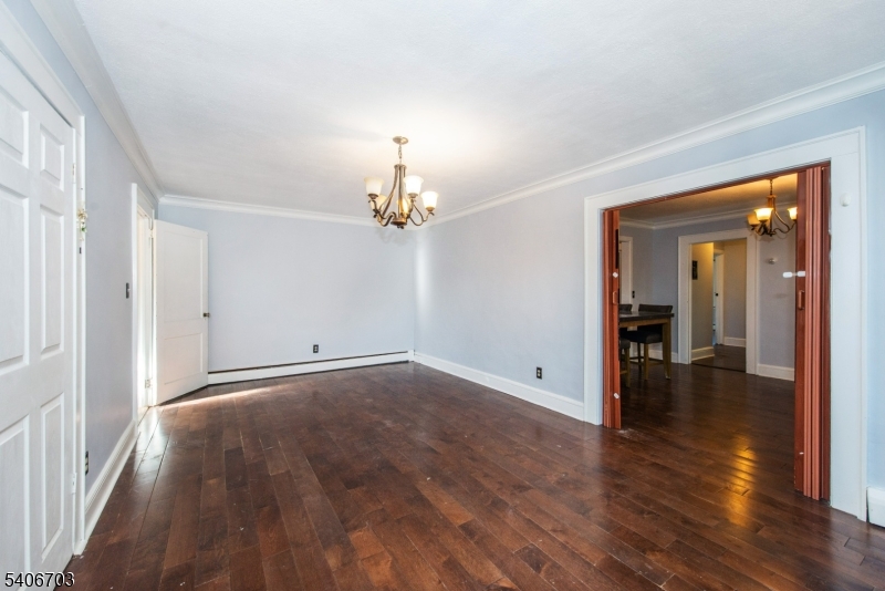 86 Watsessing Avenue, Unit 1 Bloomfield, NJ 07003 - Photo 8 of 21 wooden floor in an empty room with a window