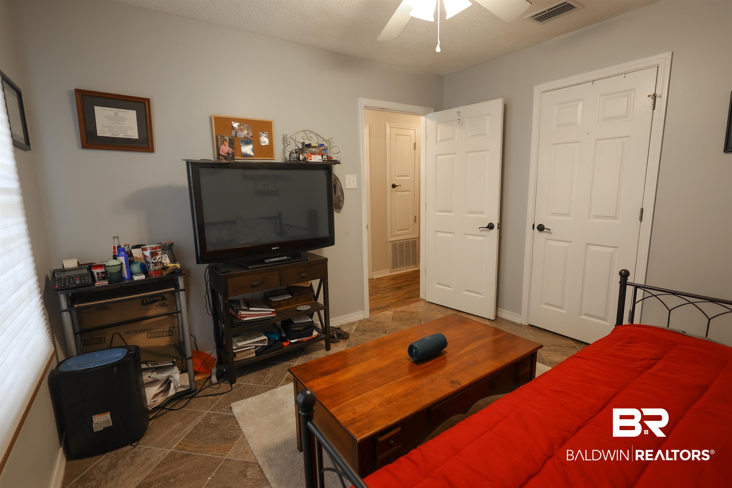 7790 Audubon Drive Foley, AL 36535 - Photo 24 of 39 Interior room featuring light gray walls, a white ceiling fan, and tile flooring