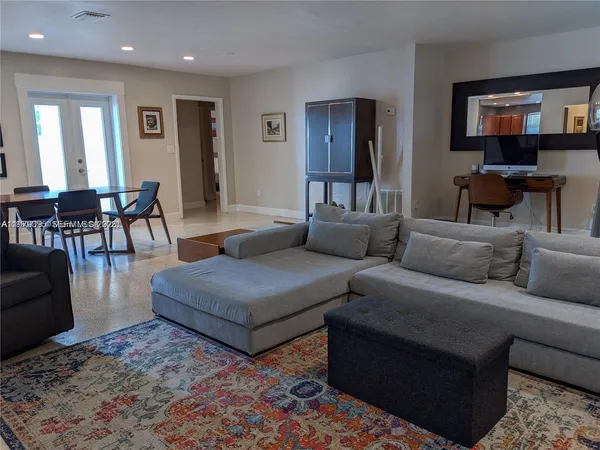 a living room with furniture and a dining area