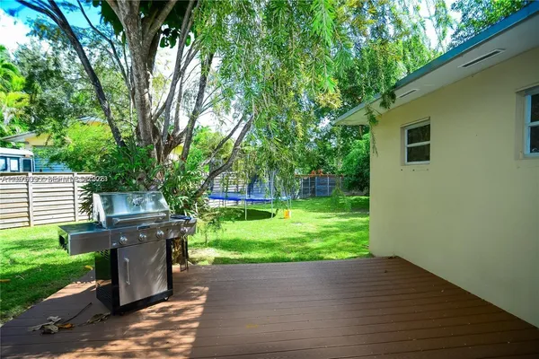 a view of backyard with outdoor seating and green space