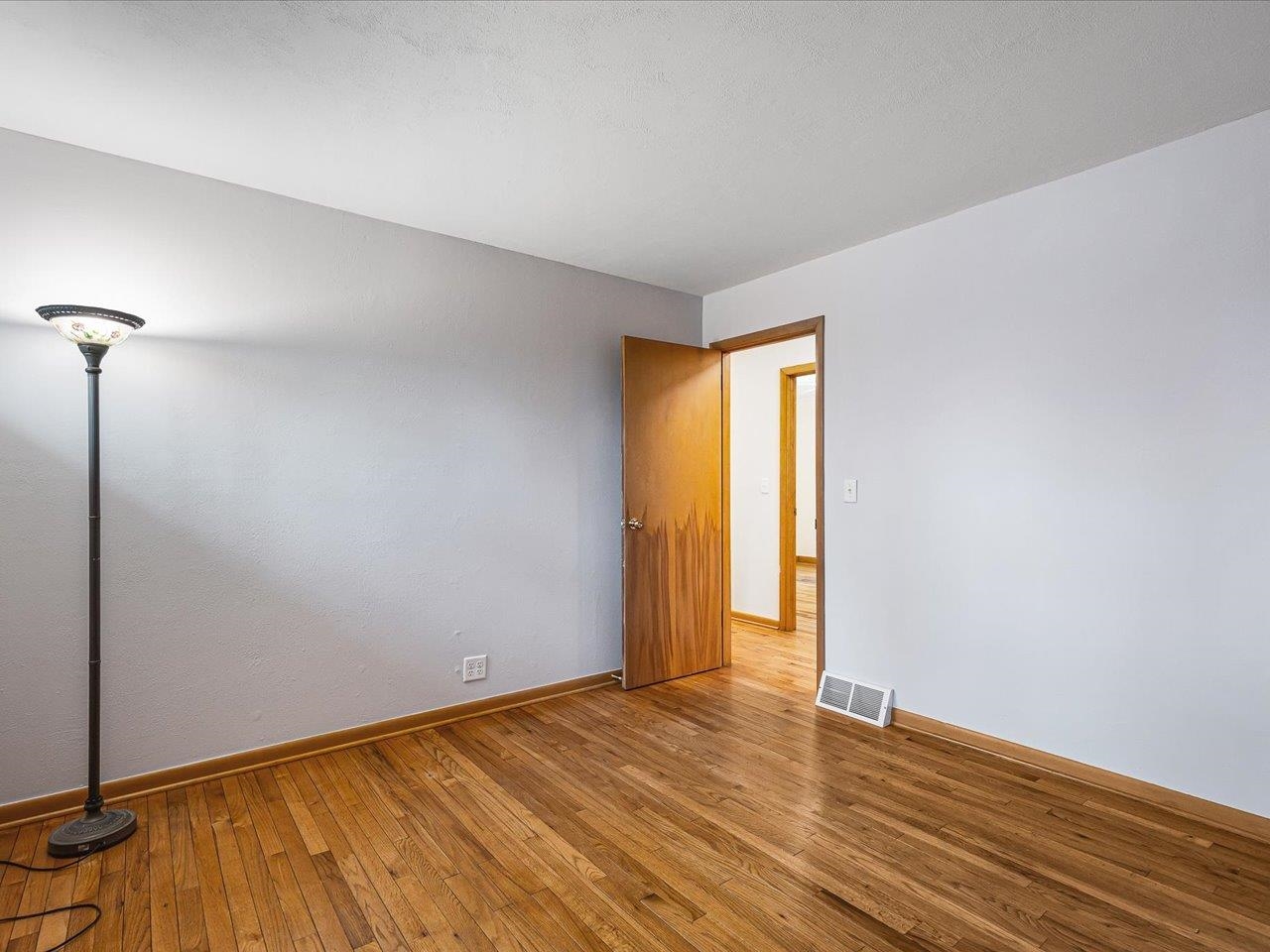 4560 Centerville Road Rockford, IL 61102 - Photo 11 of 78 a view of an empty room with wooden floor and a window