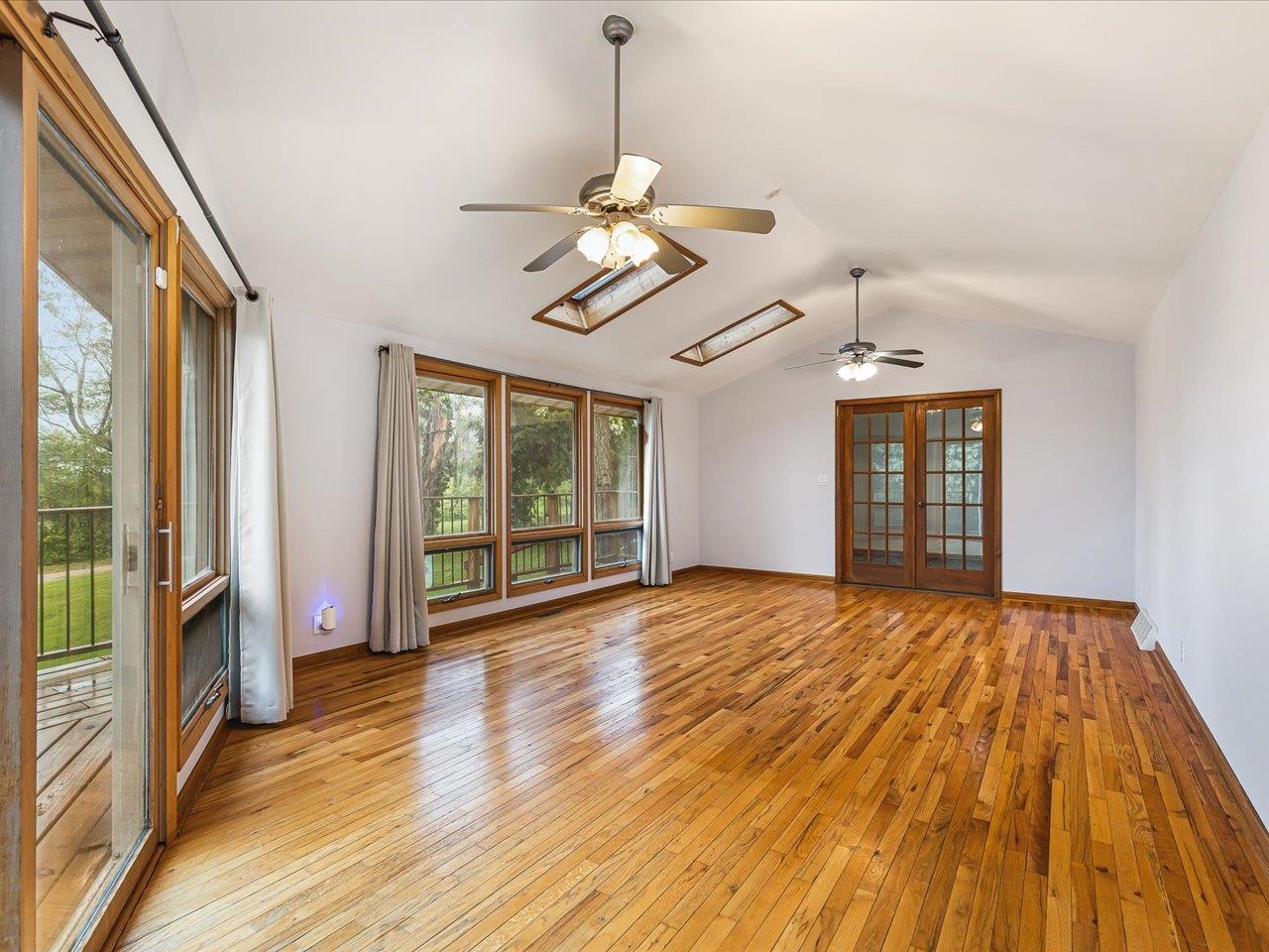 4560 Centerville Road Rockford, IL 61102 - Photo 8 of 78 a view of an empty room with wooden floor and a window