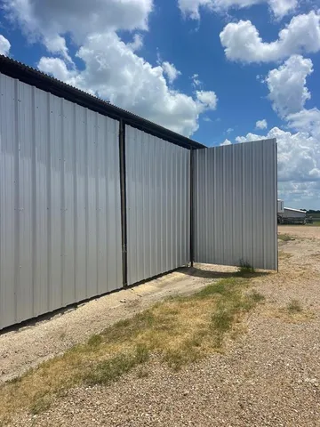 a sign board with wooden fence