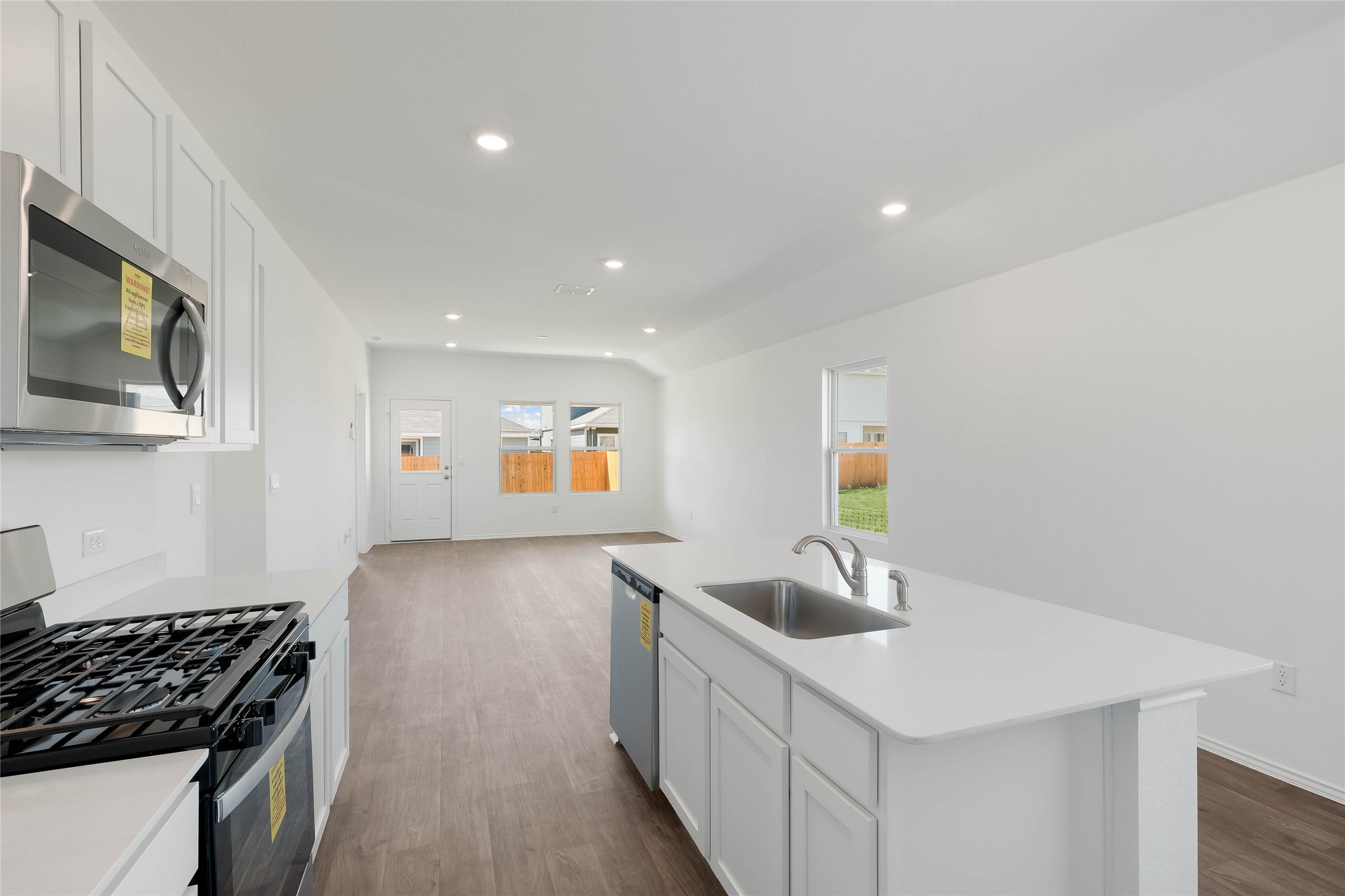 12204 Douglas Fir Circle Mustang Ridge, TX 78610 - Photo 5 of 17 a kitchen that has a sink and a stove top oven