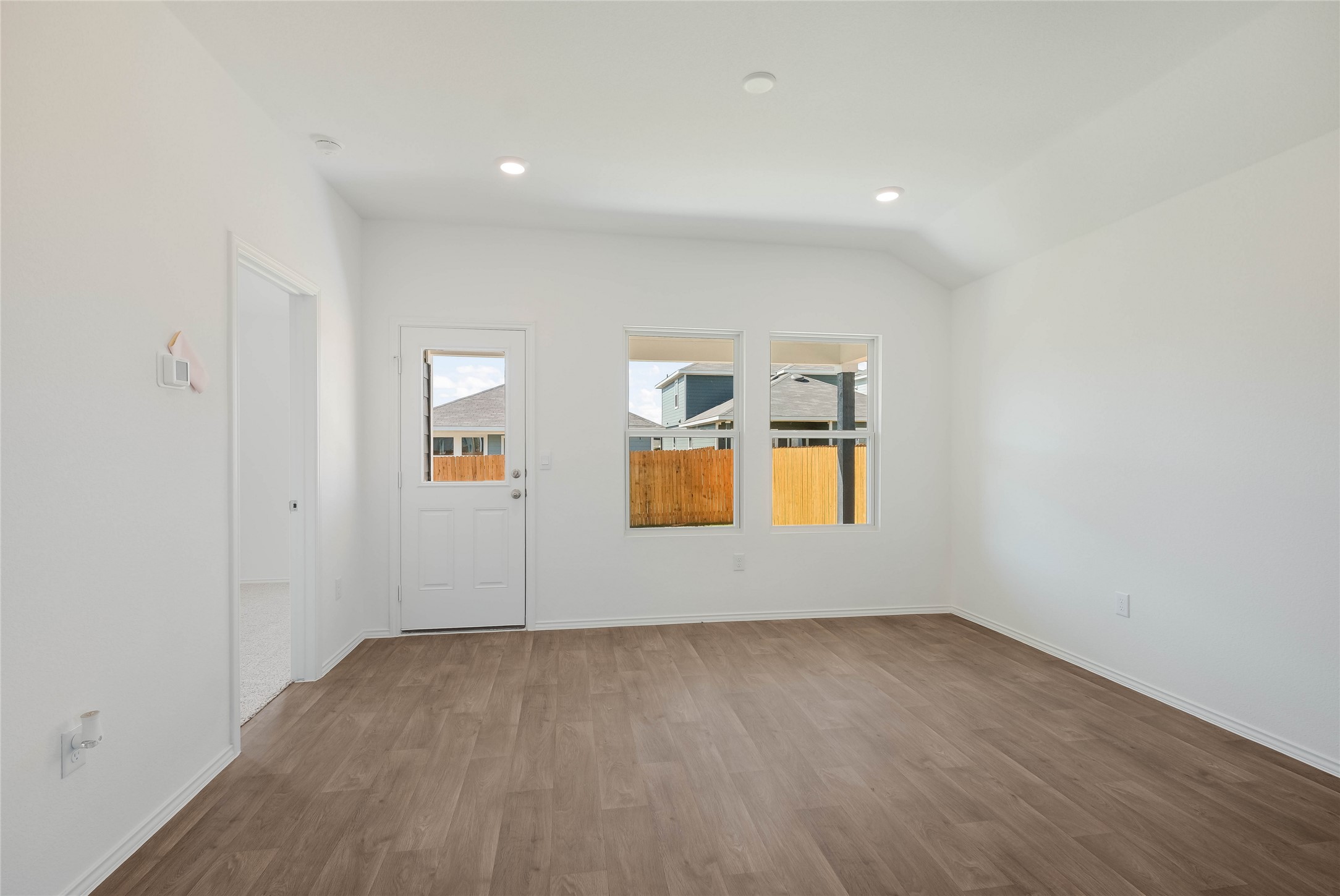12204 Douglas Fir Circle Mustang Ridge, TX 78610 - Photo 8 of 17 an empty room with wooden floor and windows