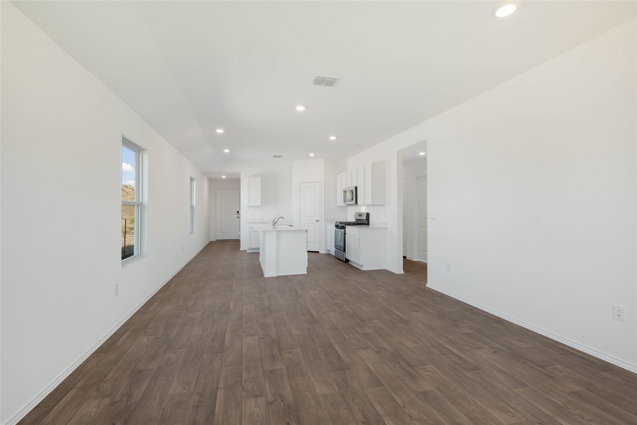 12204 Douglas Fir Circle Mustang Ridge, TX 78610 - Photo 9 of 17 a view of empty room with wooden floor