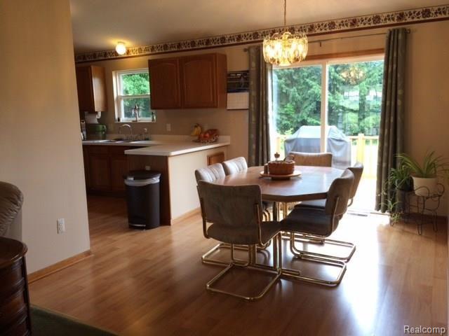 dining area has laminate floors and door wall to deck