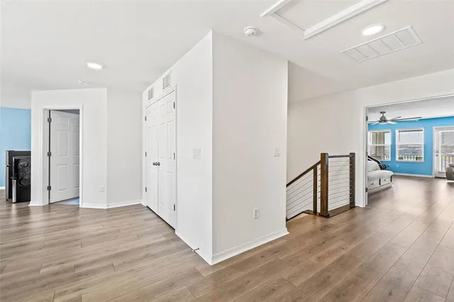 a bedroom with a bed and a ceiling fan