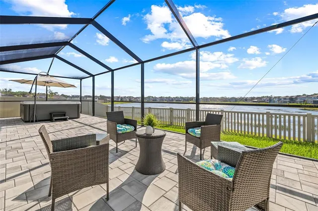 a view of a patio with a dining table and chairs