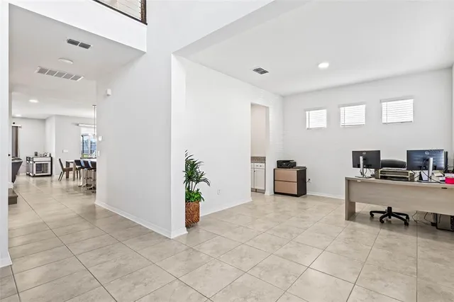 an aerial view of a house with a garden and lake view