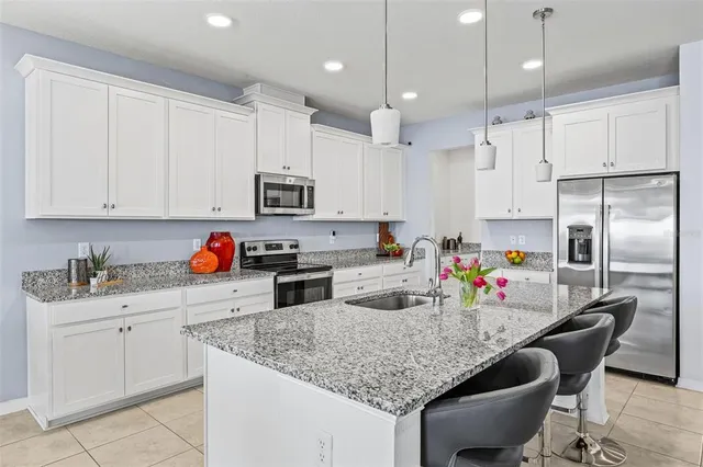 a view of a dining room with furniture and a chandelier