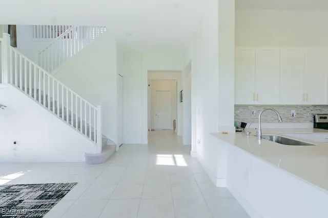 a view of a kitchen with white cabinets